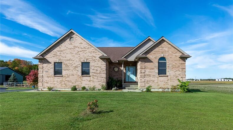 This custom brick ranch sits on ten acres in West Milton. It includes a two car attached garage and two barns with horse stalls and two arenas. CONTRIBUTED