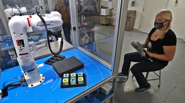Amanda Drugman works on programing a robotic arm in Clark State's robotics lab. BILL LACKEY/STAFF