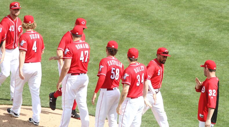 The Reds celebrate a victory over the Cardinals on Sunday, June 10, 2018, at Great American Ball Park in Cincinnati.