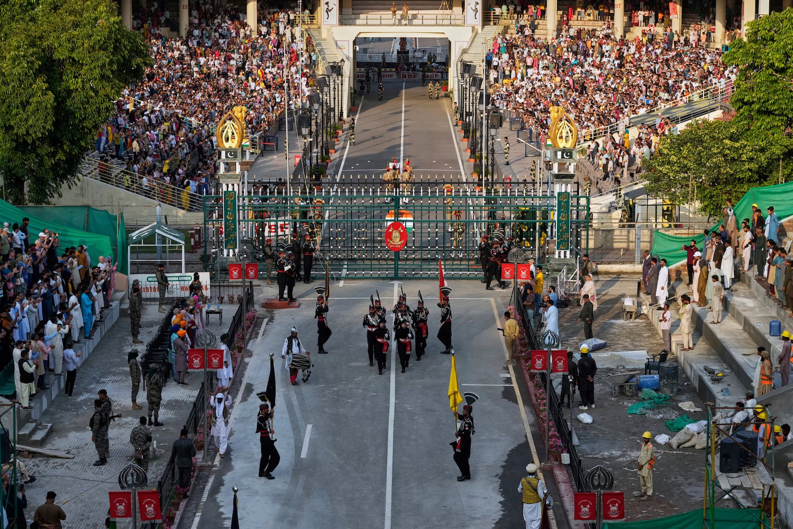 Pakistan's Rangers soldiers, bottom, and Indian Border Security Forces soldiers, top, march during a daily closing ceremony at the Wagah, a joint post on the Pakistan and India border, near Lahore, Pakistan, Monday, May 5, 2025. (AP Photo/K.M. Chaudary)