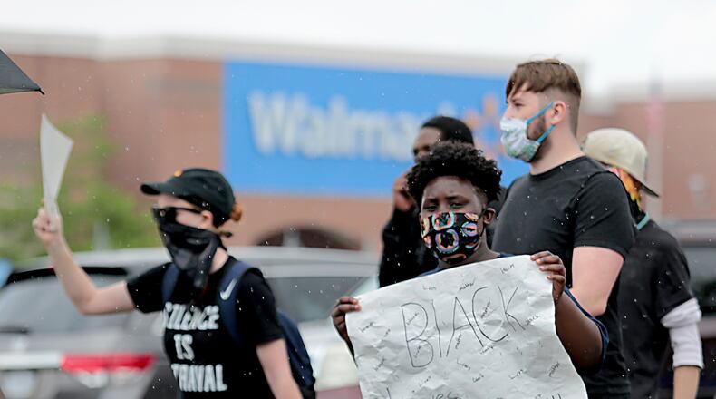 Hundreds of people gathered for a Solution Movement peaceful march and protest in front of the Beavercreek Walmart Saturday, June 13, 2020. E.L. Hubbard for the Dayton Daily News