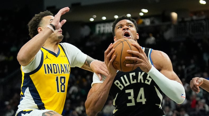 Milwaukee Bucks' Giannis Antetokounmpo (34) drives to the basket against Indiana Pacers' Jalen Slawson (18) during the second half of an NBA basketball game, Sunday, March 15, 2026, in Milwaukee. (AP Photo/Aaron Gash)