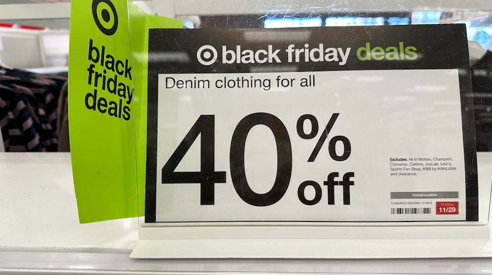 Signs denote Black Friday deals already available on clothing in a Target store, Wednesday, Nov. 26, 2025, in southeast Denver. (AP Photo/David Zalubowski)