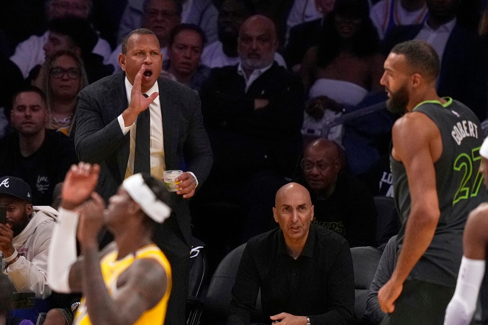 Minnesota Timberwolves co-owner Alex Rodriguez yells to center Rudy Gobert after he scored during the second half in Game 5 of an NBA basketball first-round playoff series against the Los Angeles Lakers, Wednesday, April 30, 2025, in Los Angeles. (AP Photo/Mark J. Terrill)
