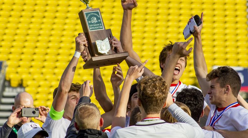Tippecanoe players hoist their first state championship soccer trophy after the Red Devils defeated Warren Howland 1-0 in the Division II state final Sunday, Nov. 10, at MAPFRE Stadium in Columbus. Jeff Gilbert/CONTRIBUTED