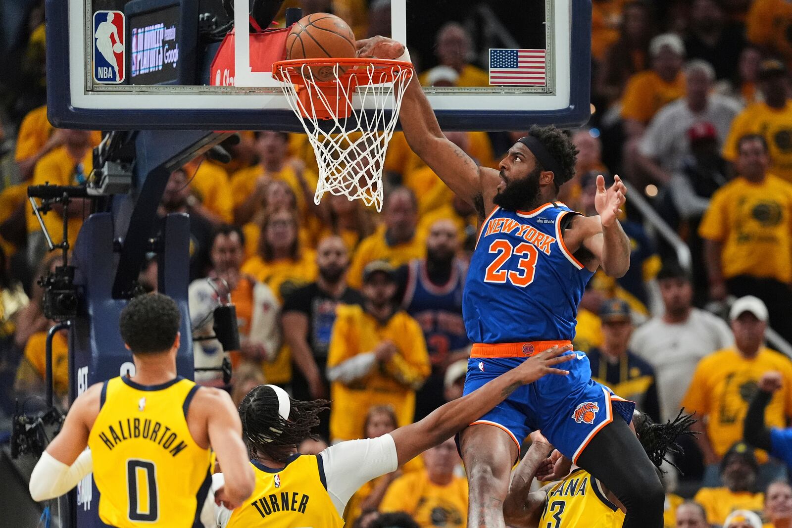 New York Knicks center Mitchell Robinson (23) dunks during the first half of Game 6 of the Eastern Conference finals of the NBA basketball playoffs against the Indiana Pacers in Indianapolis, Saturday, May 31, 2025. (AP Photo/Michael Conroy)