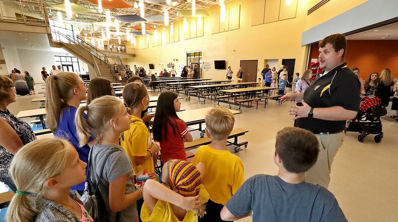 Brian Kuhn, superintendent of Clark-Shawnee Schools, tells some elementary school students about their new school during an open house when it opened. BILL LACKEY/STAFF