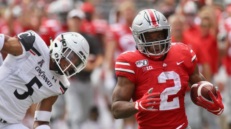 Ohio State’s J.K. Dobbins runs for a touchdown as Cincinnati’s Darrick Forrest, left, watches on Saturday, Sept. 7, 2019, at Ohio Stadium in Columbus. David Jablonski/Staff