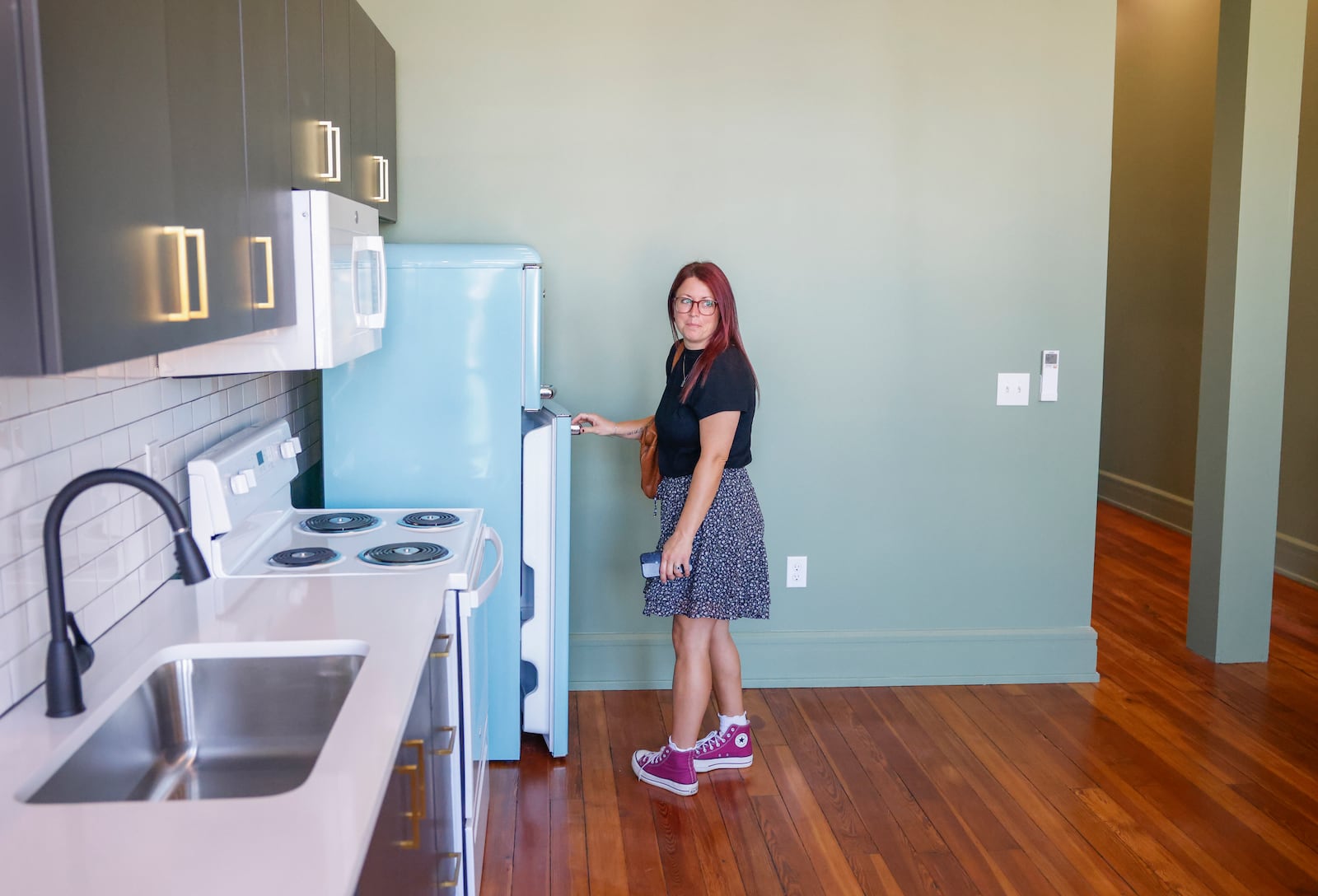 Alixandria Good checks out a refrigerator in the Willman Lofts during the Willman Building grand opening on Friday, September 12, 2025, in Urbana. JOSEPH COOKE/STAFF