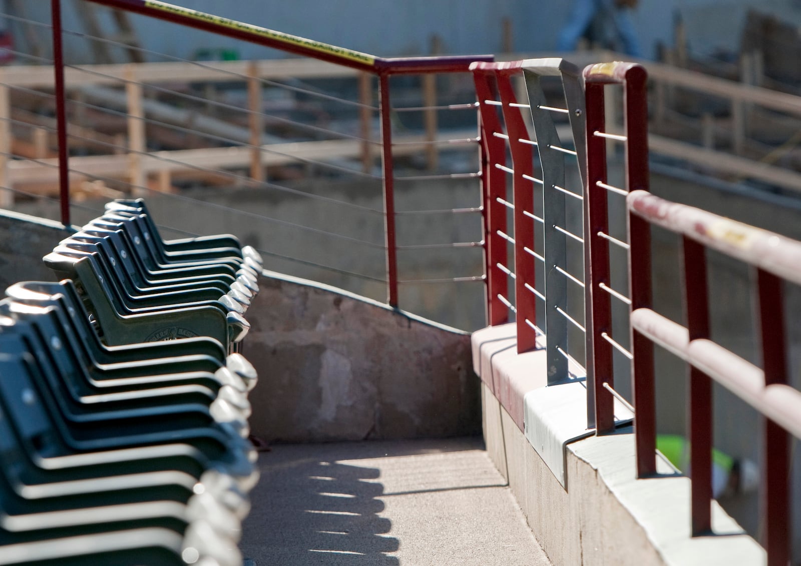 FILE - Current railings, ar right, in front of the outfield stands at Rangers Ballpark in Arlington are 36 1/4 inches in front of the seats and 42 inches tall at the end of each isle, will be raised to a uniform 42 inches as renovations continue, Thursday, Jan. 5, 2012, in Arlington, Texas. The new railing design is at center. (AP Photo/Brandon Wade, File)