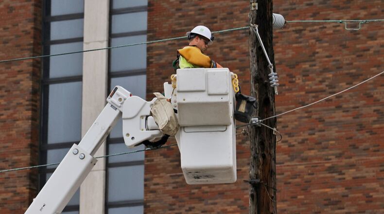 Hamilton city crews work to restore power on Dayton Street after storms with heavy rain and strong winds caused power outages and down trees and limbs around Butler County Monday evening, June 13, 2022. NICK GRAHAM/STAFF