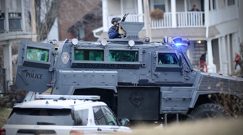 Members of the Springfield Police Division's Special Response Team prepared to enter a house on South Race Street looking for a shooting suspect Monday, Jan. 2, 2023. MARSHALL GORBY \STAFF