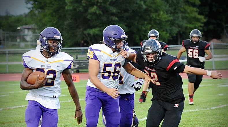 Bellbrook’s Elijah Brooks (22) and Mohammad Al-Halawat (56) turn upfield blocking Tecumseh’s Andrew Lowe (52) during Friday night action at Tecumseh high school. MARSHALL GORBY\STAFF
