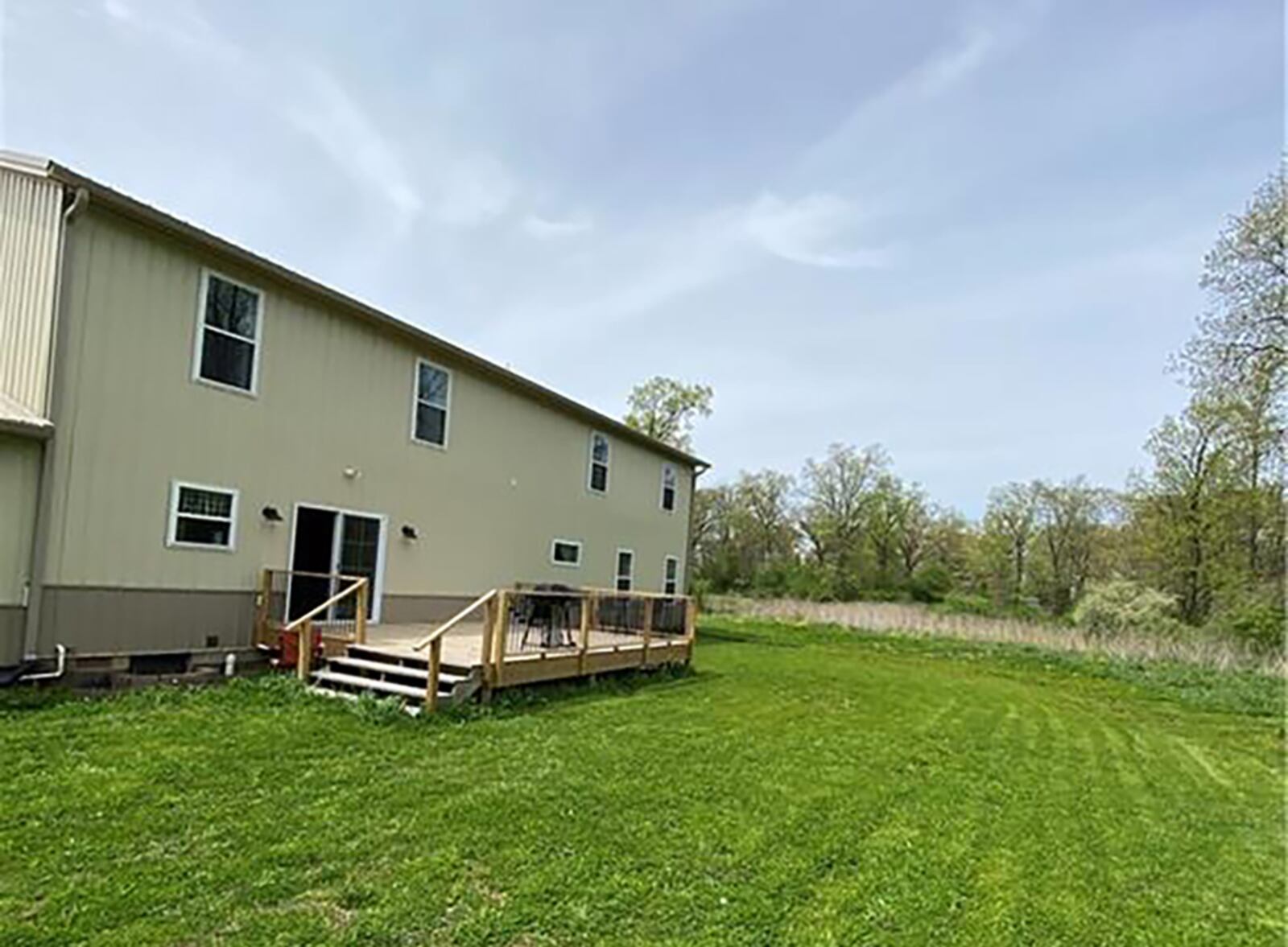 Sliding glass doors off the kitchen lead to a wood deck that overlooks the wooded back yard. The home is set of 4.37 acres. CONTRIBUTED PHOTO