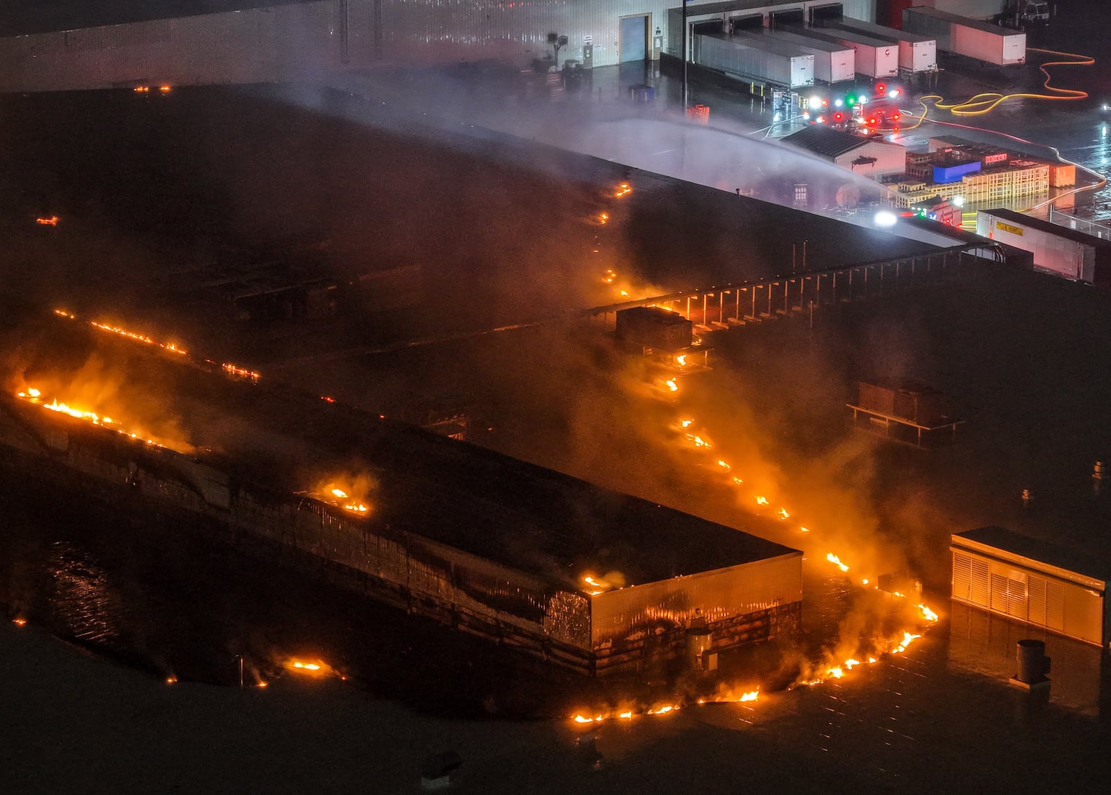 Flames from the Fuyao Glass America fire could be seen three hours after the fire started around 8:30 p.m. Sunday, March 22, 2026 in Moraine. Drone photos by Nick Graham / Staff