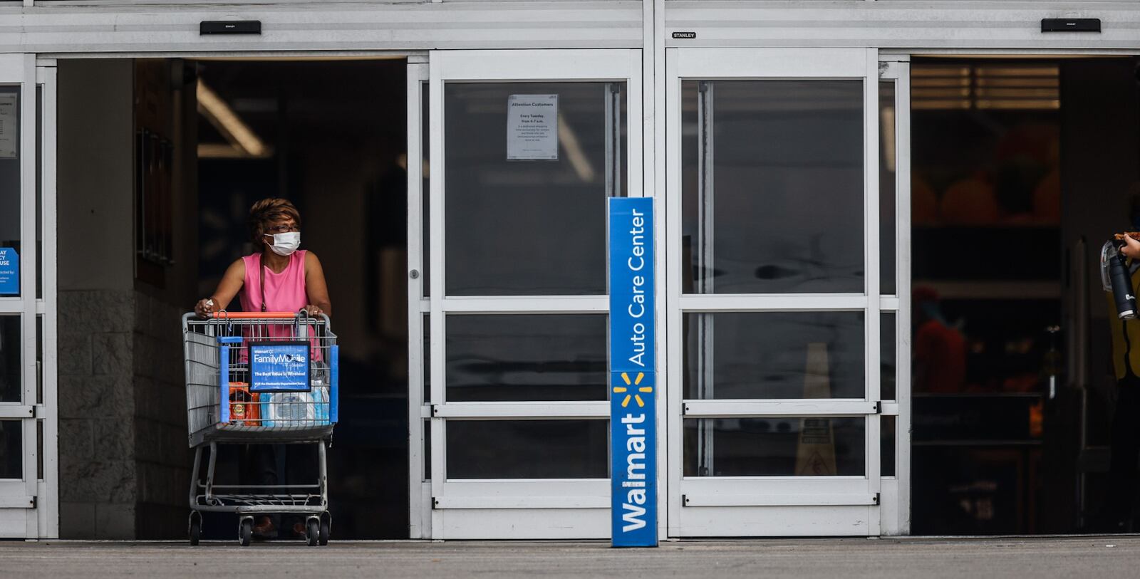 A Walmart shopper exits the store wearing a mask Thursday July 29, 2021. JIM NOELKER/STAFF