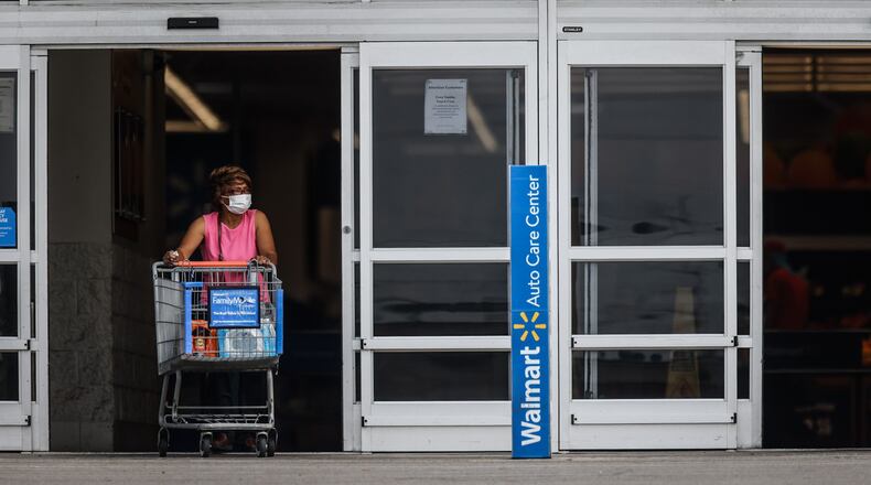 A Walmart shopper exits the store wearing a mask Thursday July 29, 2021 The CDC recommended on Tuesday that in areas with high community COVID-19 transmission rates, fully vaccinated individuals should don a face mask. JIM NOELKER/STAFF