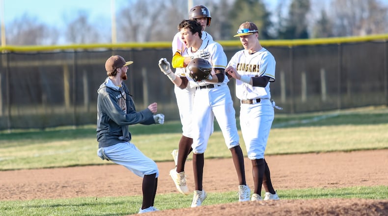 Kenton Ridge senior Chase Marrs celebrates with his teammates after hitting a two RBI walk-off double to lift the Cougars to a 4-3 victory at Tom Randall Field on Wednesday evening. The Cougars improved to 2-0 on the season. CONTRIBUTED PHOTO BY MICHAEL COOPER
