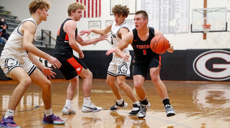 Cutline: West Liberty-Salem High School senior Nick Burden dribbles through several Greenon defenders during their game earlier this season in Springfield. Michael Cooper/CONTRIBUTED