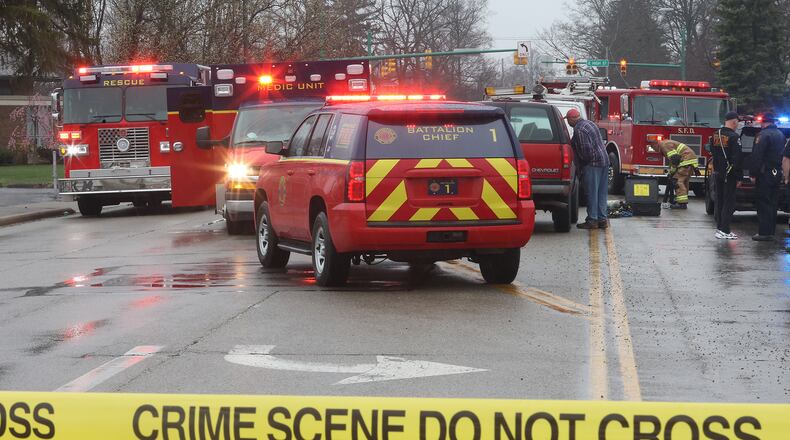 A pedestrian was killed after being struck and trapped under a work van on Belmont Avenue between High Street and Main Street Tuesday afternoon. BILL LACKEY/STAFF