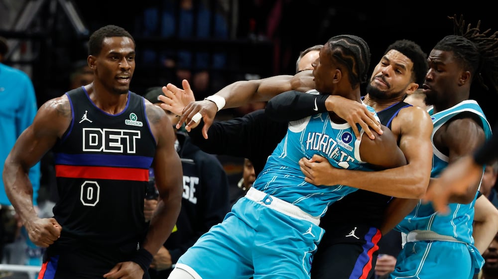 Charlotte Hornets forward Moussa Diabate, front right, is held back as he fights with Detroit Pistons center Jalen Duren (0) fight during the second half of an NBA basketball game in Charlotte, N.C., Monday, Feb. 9, 2026. (AP Photo/Nell Redmond)