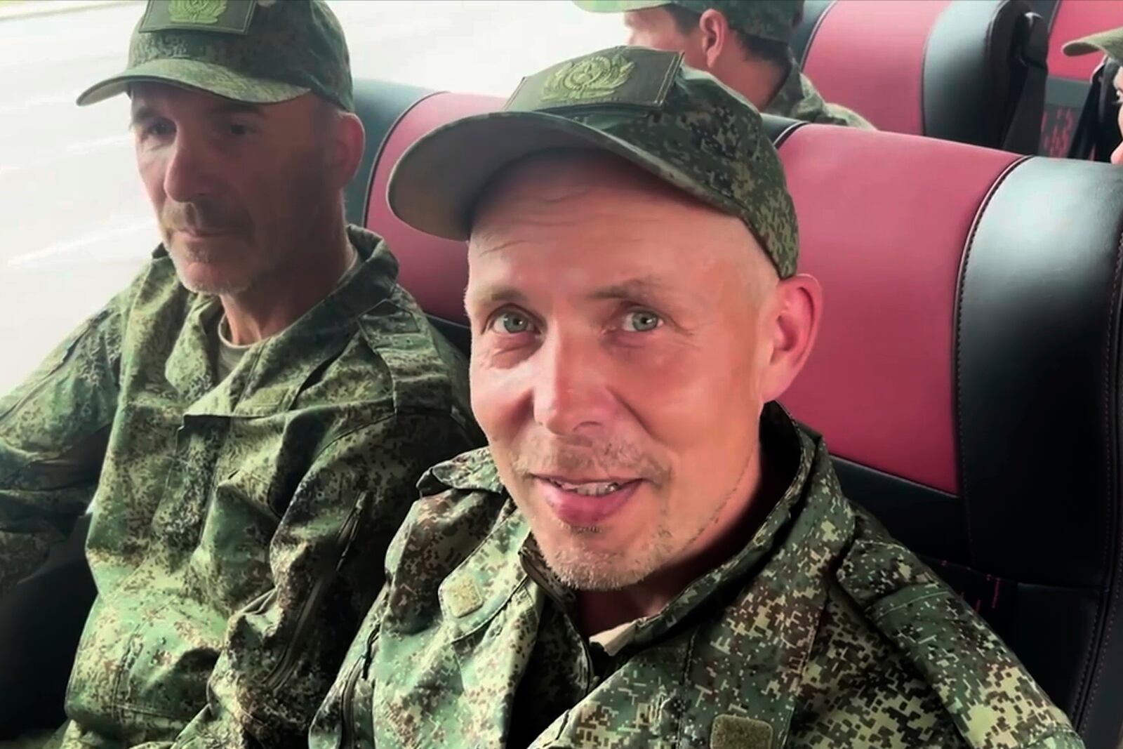 In this photo, taken from a video released by Russian Defense Ministry press service, Russian servicemen sit in a bus after returning from captivity after an exchange between Russia and Ukraine, at an undisclosed location in Belarus, Saturday, May 24, 2025. (Russian Defense Ministry Press Service via AP)