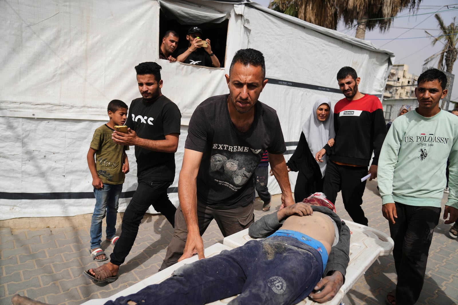 A Palestinian man killed in an Israeli airstrike on central Gaza Strip is brought to Al-Aqsa Hospital in Deir al-Balah, on Saturday, May 17, 2025. (AP Photo/Abdel Kareem Hana)