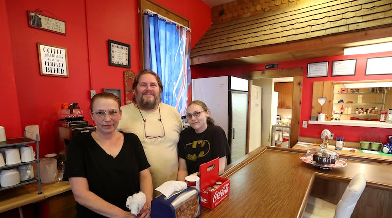 Mandie Warner, owner of Sis’s Restaurant in Catawba, and employees Paul Koenig and Lexi Herron behind the counter at the restaurant. BILL LACKEY/STAFF