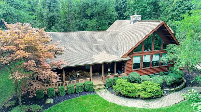 The 3-bedroom, log home with about 2,740 sq. ft. of living space, has a matching detached, 2-car log garage. The home includes a 4-season room, partially finished basement and loft. CONTRIBUTED PHOTO