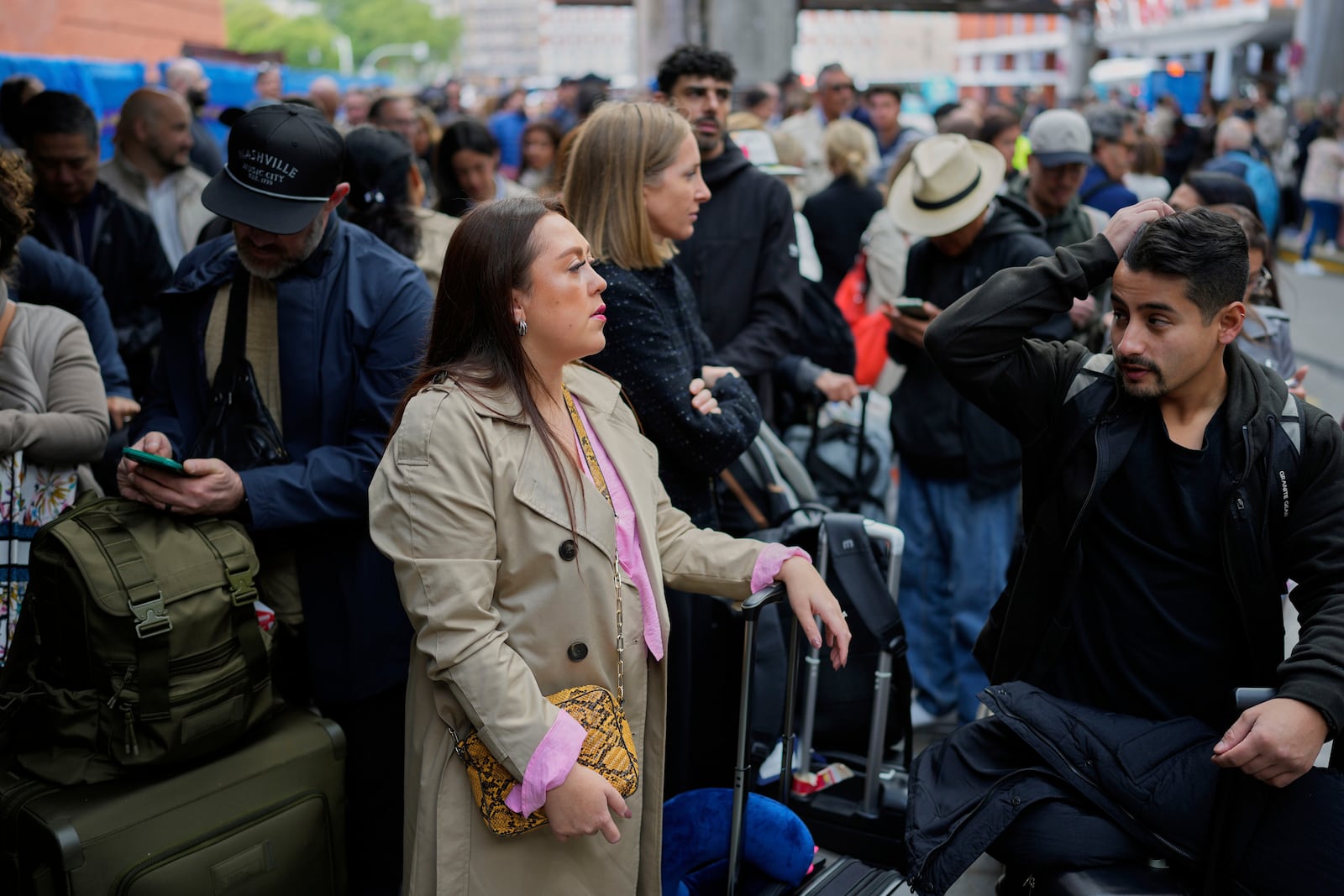 Travelers wait for news about their delayed trains at the Madrid train station, Spain, Monday, May 5, 2025. (AP Photo/Manu Fernandez)