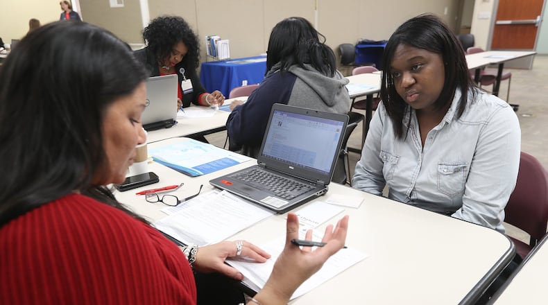 Tylysha Leslie interviews with Kelly Howard, a health care recruiter, during the MercyHealth job fair Friday at the Springfield Regional Medical Center. Bill Lackey/Staff
