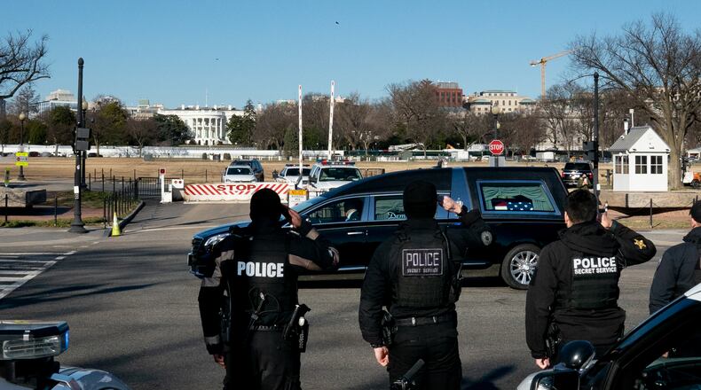 The hearse carrying the body of Brian Sicknick, the U.S. Capitol police officer who died as a result of injuries from an attack on the complex, passes in front of the White House in Washington, Jan. 10, 2021. Democrats plan to charge President Donald Trump with high crimes and misdemeanors for his role inciting a mob at the Capitol. (Erin Scott/The New York Times)