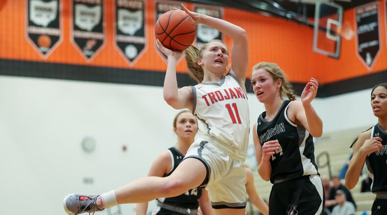 Southeastern High School sophomore Brooke Nelson drives the ball to the hoop in front of Covington sophomore Maggie Anderson (right) during their game on Wednesday night at Versailles High School. The Buccaneers won 53-36. Michael Cooper/CONTRIBUTED