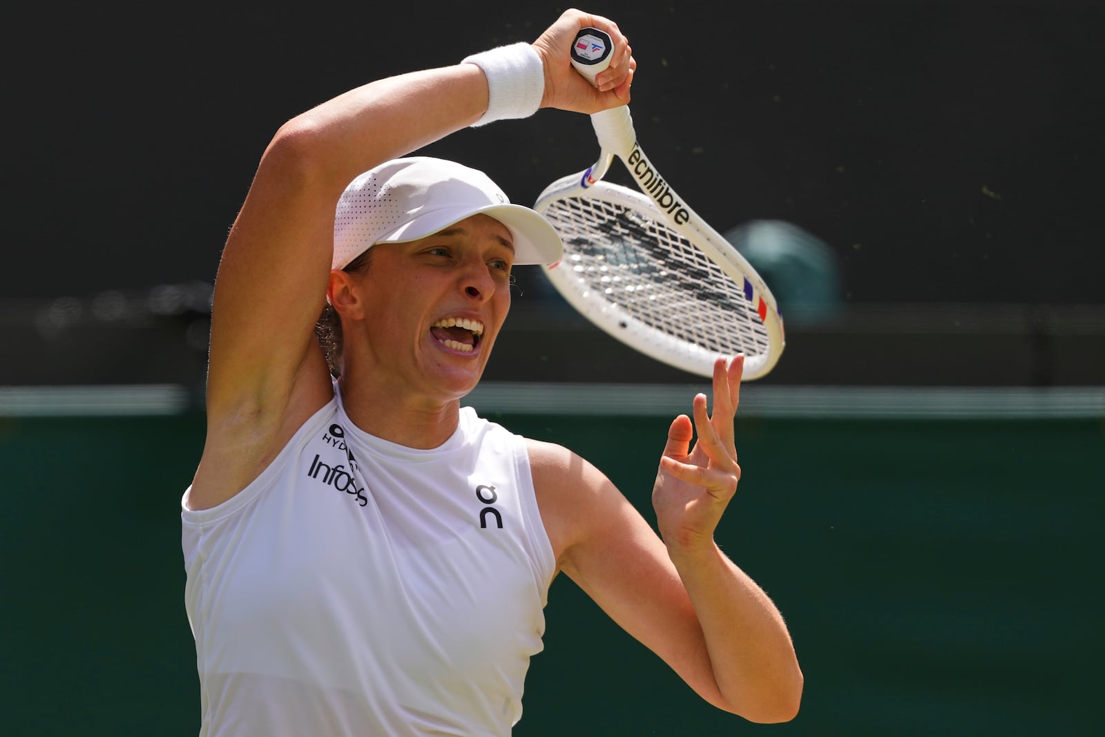 Iga Swiatek of Poland plays a return to Liudmilla Samsonova of Russia during the women's singles quarter final match at the Wimbledon Tennis Championships in London, Wednesday, July 9, 2025.(AP Photo/Kirsty Wigglesworth)