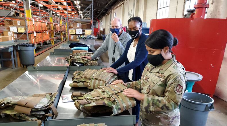 Dr. Daniel Mountjoy (left), Christine Villa, and Maj. Saily Rodriguez, with the Air Force Life Cycle Management Center's Human Systems Division, perform an inspection on new body armor units designed specifically for female Airmen in Security Forces. (U.S. Air Force photo / Brian Brackens)