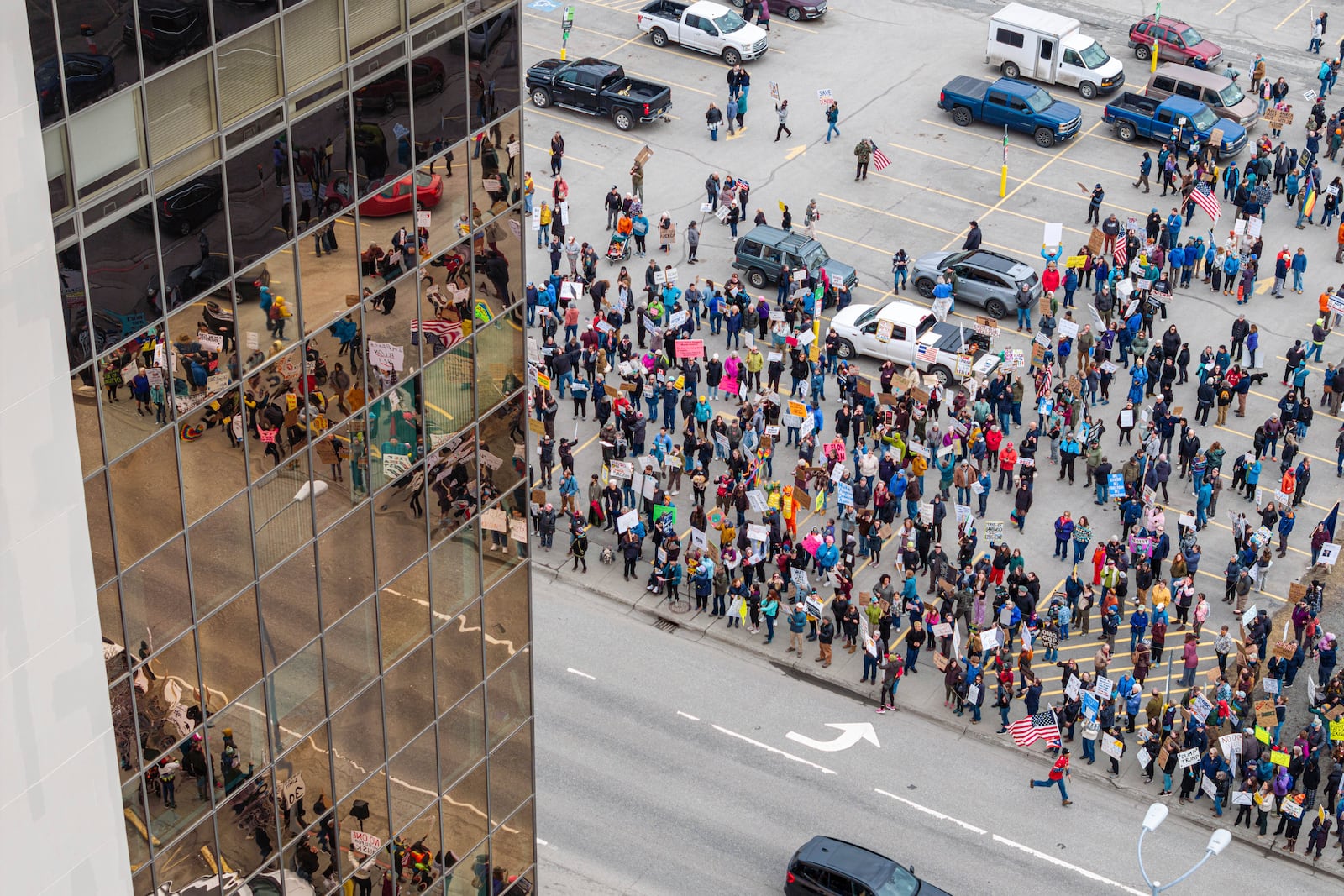 People gather outside the offices of Sen. Lisa Murkowski and Dan Sullivan during a protest against President Trump and his policies on Saturday, April 19, 2025 in Anchorage, Alaska. (Loren Holmes/Anchorage Daily News via AP)