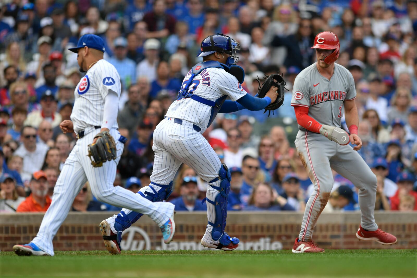 Chicago Cubs catcher Christian Bethancourt tags out Cincinnati Reds' Tyler Stephenson during a run down between third base and home plate during the fourth inning of a baseball game in Chicago, Sunday, Sept. 29, 2024. (AP Photo/Paul Beaty)