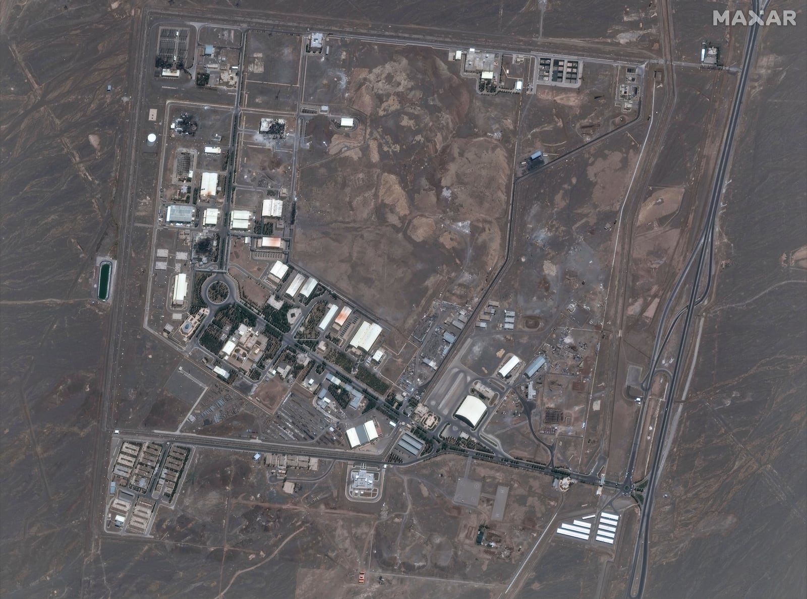 This satellite image provided by Maxar Technologies shows the Natanz nuclear enrichment facility, where multiple buildings were destroyed from recent Israeli airstrikes, 135 miles southeast of Tehran, Iran, Saturday, June 14, 2025. (Maxar Technologies via AP)