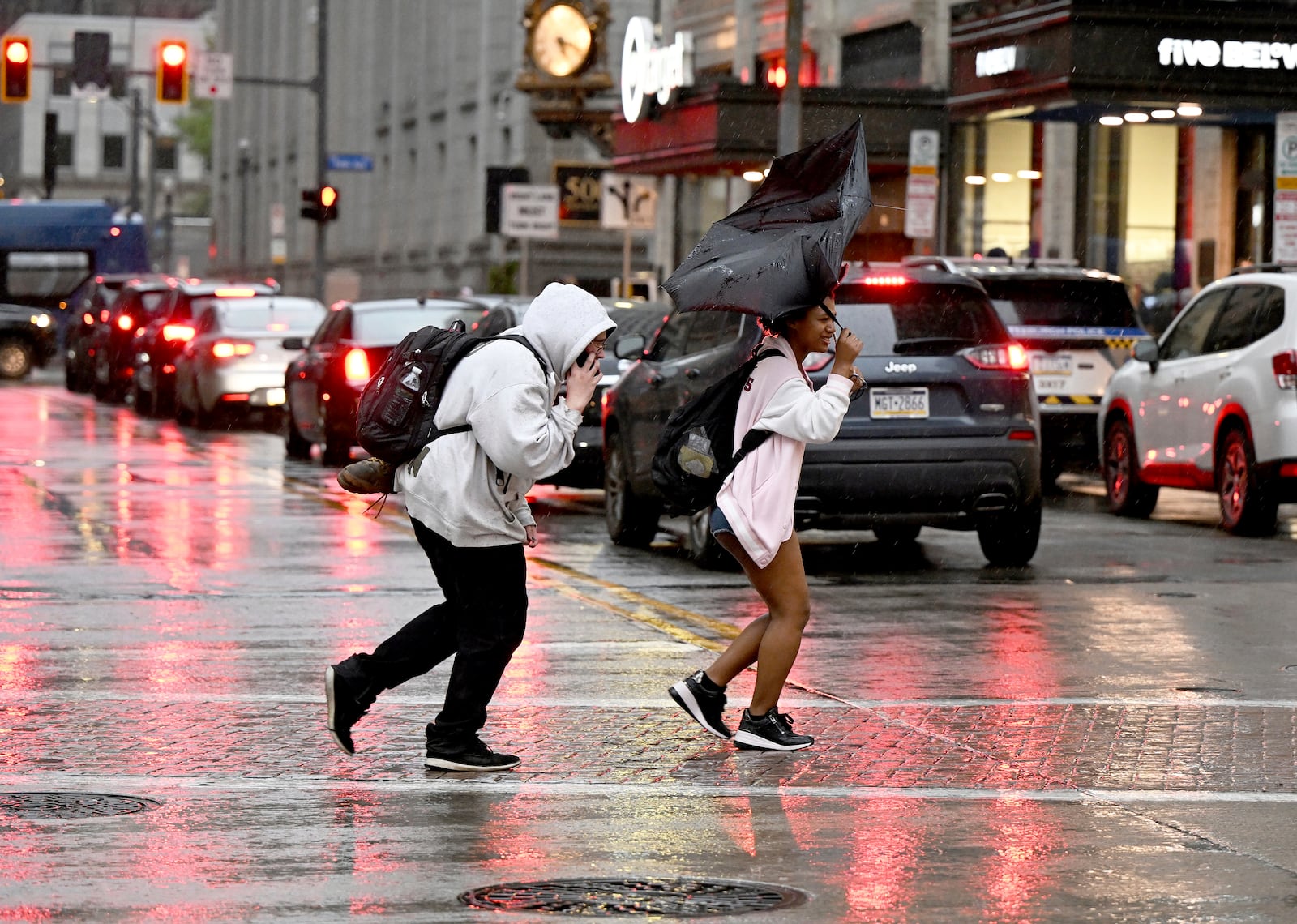 Pedestrians rush across Smithfield St. in the rain in Downtown Pittsburgh on Tuesday, April 29, 2025. (Sebastian Foltz/Pittsburgh Post-Gazette via AP)