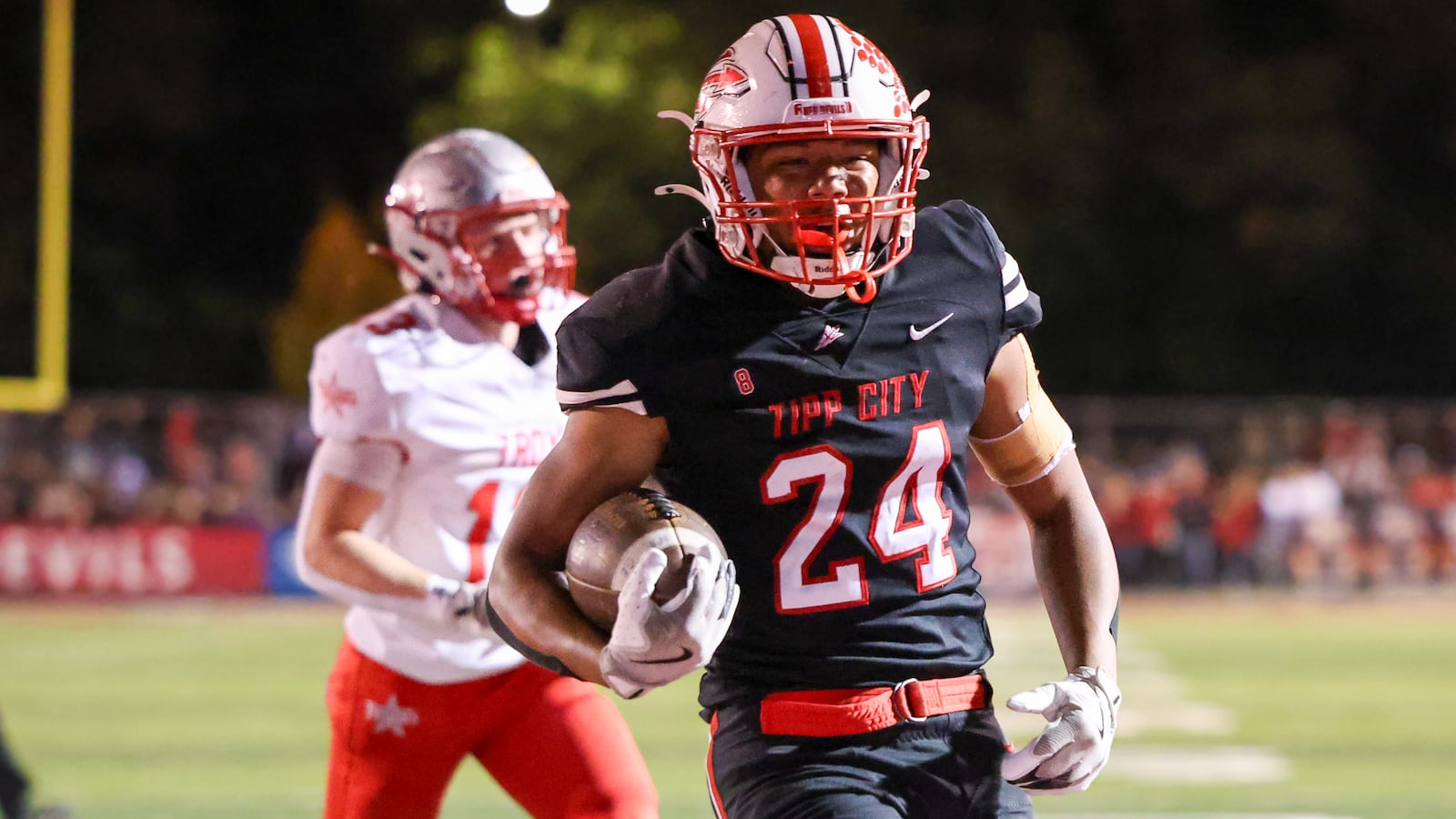 Tippecanoe senior running back Xavier Melton scores on a 5-yard touchdown run in the third quarter of a Miami Valley League game on Friday in Tipp City Park. BRYANT BILLING / STAFF