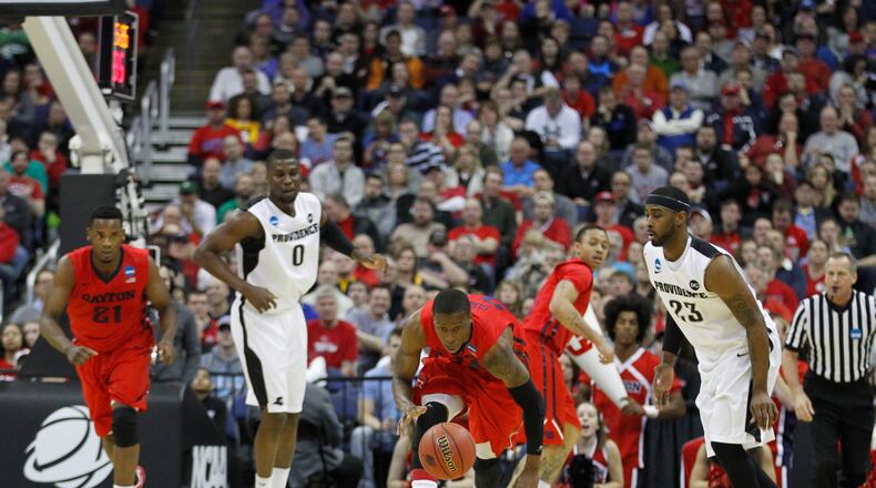 Dayton's Jordan Sibert picks up a loose ball and heads up the court in the first half against Providence in the second round of the NCAA tournament on Friday, March 20, 2015, at Nationwide Arena in Columbus. David Jablonski/Staff