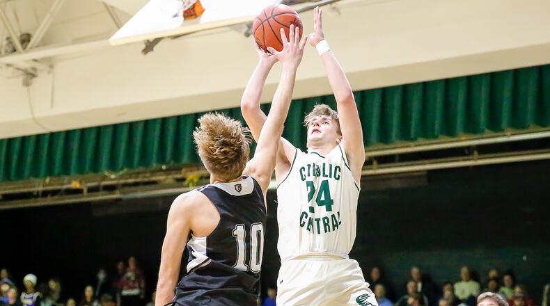 Catholic Central High School junior Tyler Galluch shoots the ball over Greenon's Jaden Journell during their game on Tuesday night at Jason Collier Gymnasium in Springfield. Galluch scored 27 points as the Irish won 71-40. CONTRIBUTED PHOTO BY MICHAEL COOPER