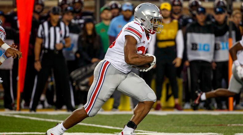 Ohio State running back Master Teague III (33) rushes against Minnesota in the second quarter of an NCAA college football game Thursday, Sept. 2, 2021, in Minneapolis. (AP Photo/Bruce Kluckhohn)