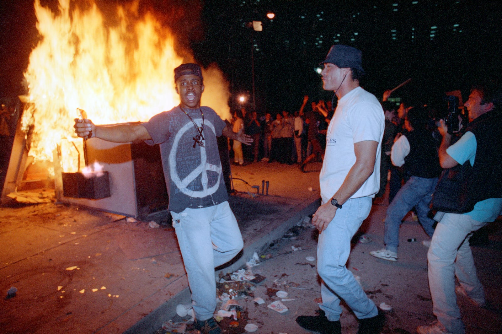 FILE - In this April 29, 1992 file photo, demonstrators protest the verdict in the Rodney King beating case in front of the Los Angeles Police Department headquarters in Los Angeles. (AP Photo/Nick Ut, File)