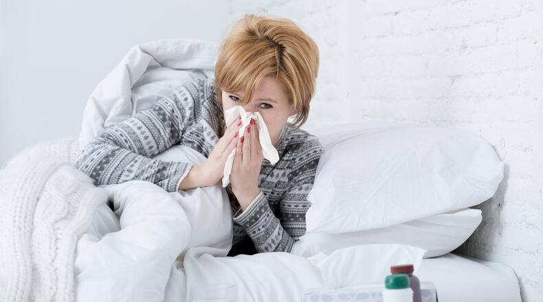 The influenza virus hijacks human cells in the nose and throat to make copies of itself. (Dreamstime)