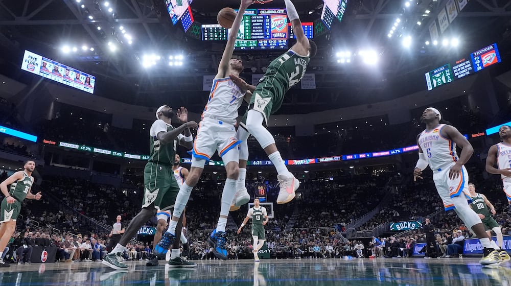Milwaukee Bucks' Giannis Antetokounmpo dunks over Oklahoma City Thunder's Chet Holmgren during the second half of an NBA basketball game Wednesday, Jan. 21, 2026, in Milwaukee. (AP Photo/Morry Gash)