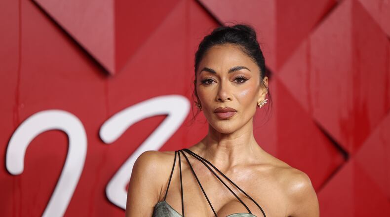 Nicole Scherzinger poses for photographers upon arrival at the British Fashion Awards on Monday, Dec. 4, 2023 in London. (Vianney Le Caer/Invision/AP)