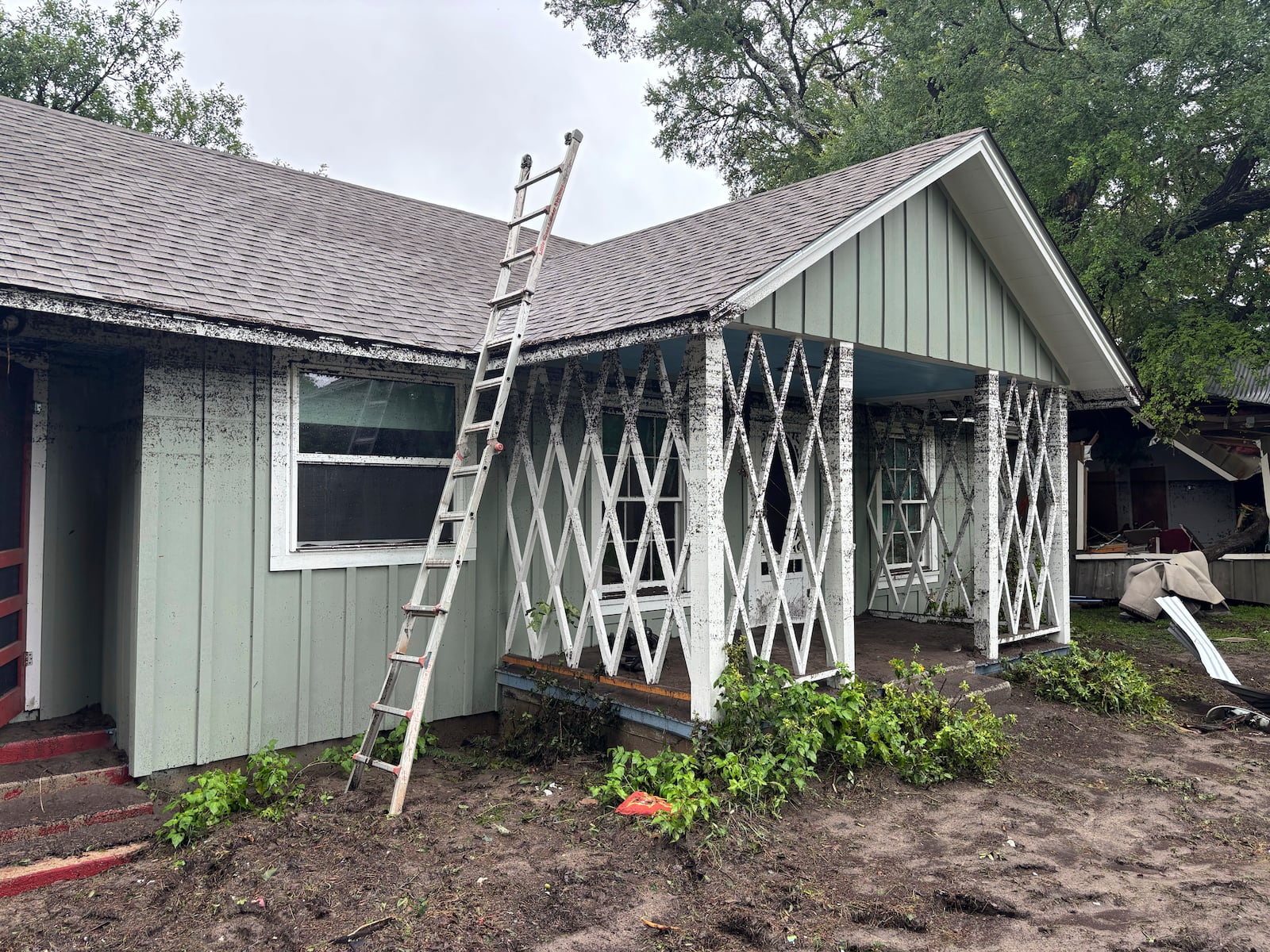 Lines on the exterior of a cabin mark the height of floodwaters from the Guadalupe River in Hunt, Texas, at 2:34 p.m. on Friday, July 4, 2025. (Shabd Simon-Alexander via AP)