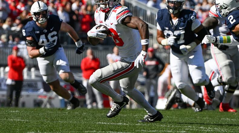 Ohio State wide receiver Marvin Harrison Jr. (18) runs away from Penn State defenders Nick Tarburton (46) and PJ Mustipher (97) during the first half of an NCAA college football game, Saturday, Oct. 29, 2022, in State College, Pa. (AP Photo/Barry Reeger)