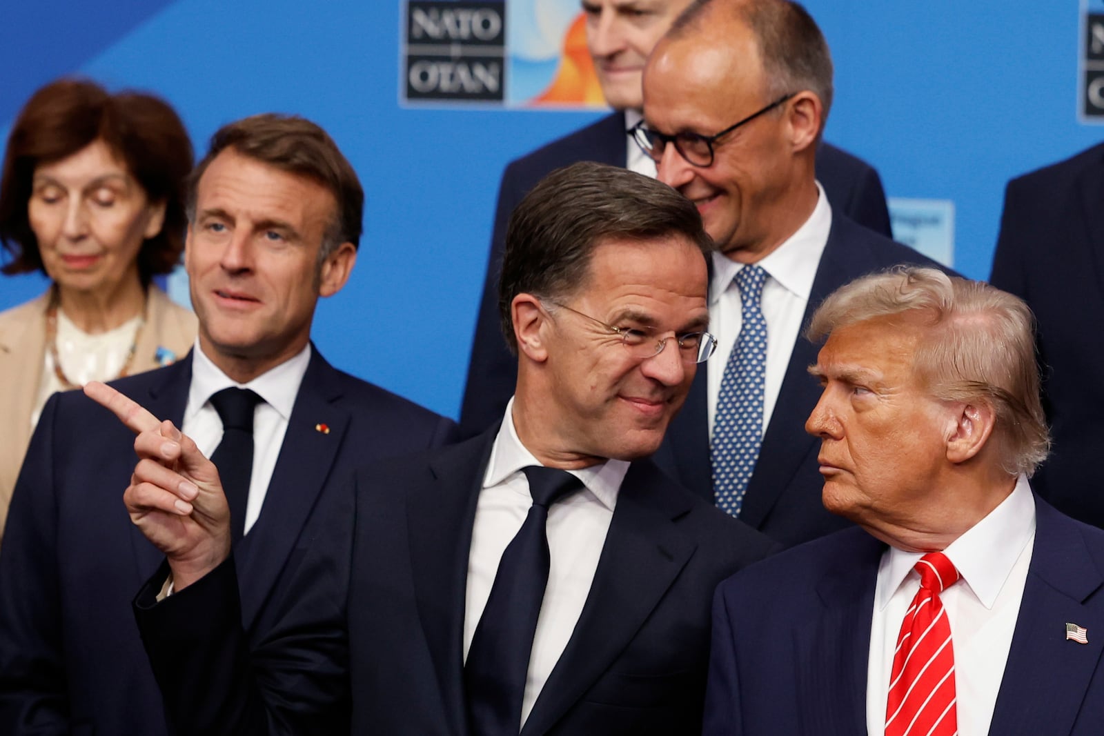 President Donald Trump, right, speaks with NATO Secretary General Mark Rutte during a group photo of NATO heads of state and government at the NATO summit in The Hague, Netherlands, Wednesday, June 25, 2025. (AP Photo/Geert Vanden Wijngaert)